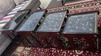 set of 4 wooden nesting table with glass design top