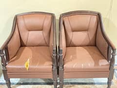 2 brown leather sitting chair