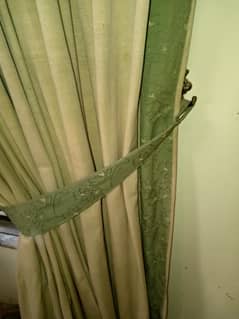 Golden curtains with light green beautiful border on a throw away pri