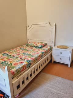 single bed with side table