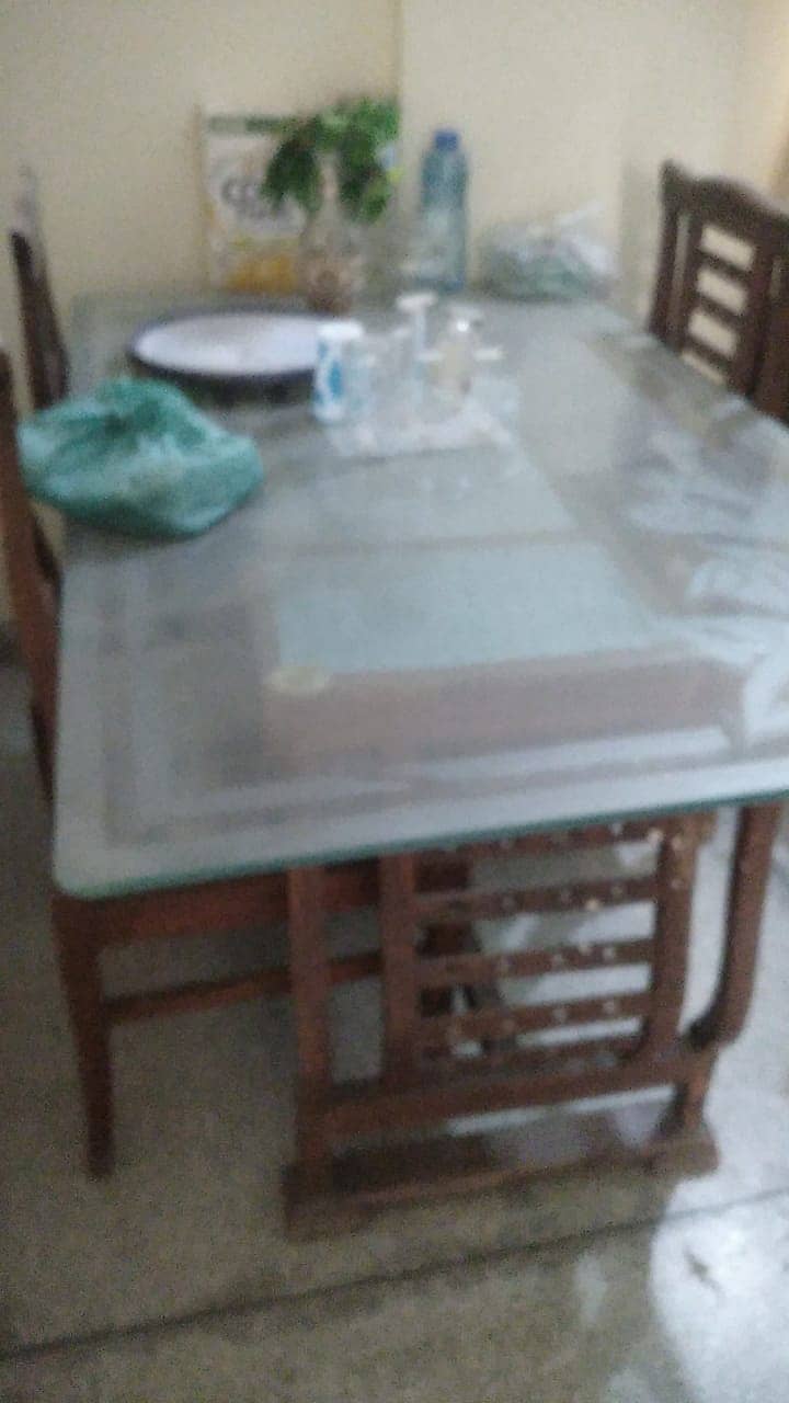 Wooden table with new covering on chairs 6 seaters 0