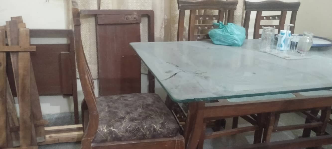 Wooden table with new covering on chairs 6 seaters 4