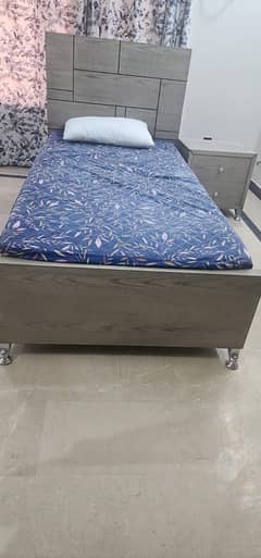 single beds with side tables