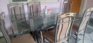 Dining table of glass with chairs