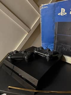 PS4 WITH 2 CONTROLLERS AND GAMES