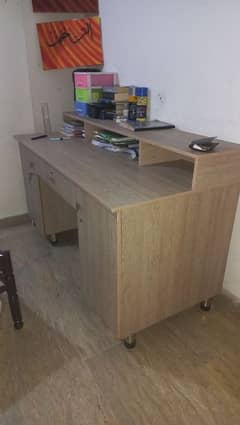 study table with drawer and side cabinets.