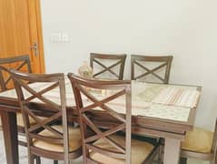 wooden framed glass top dining table + six chairs