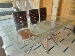 large dining table of glass with chairs