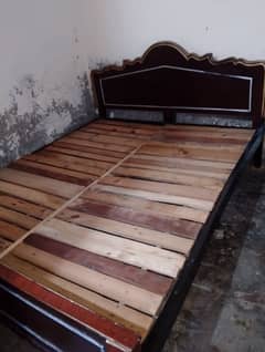 wooden bed with one side table