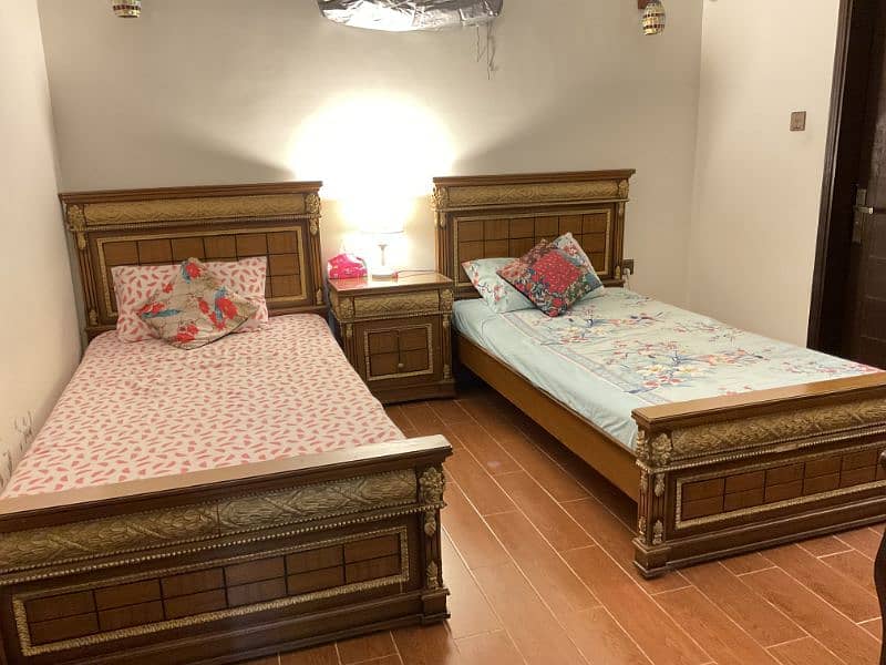 2 Single beds with 2 side tables ( mattress included) 1