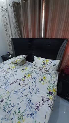 double bed with mattress with two side tables