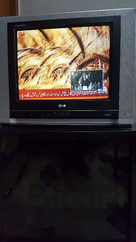 LG 21 inch CRT television with trolly and remote. 7