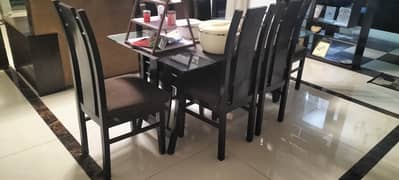 Gently used dining table with glass top and six chairs. (FOR SALAE!)