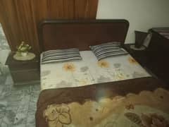 Double bed with side table and dressing table