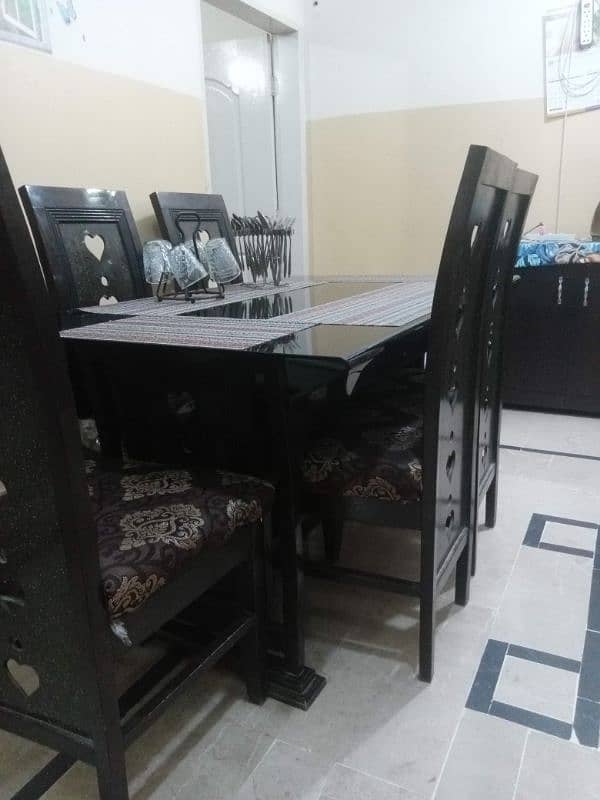 dinning table with six wooden chairs 0