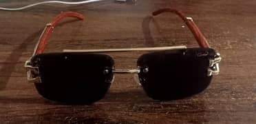 Sunglasses with golden & wooden color frame & black glass