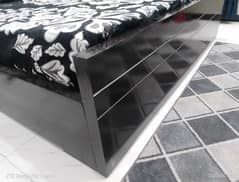 black wooden bed with matrass