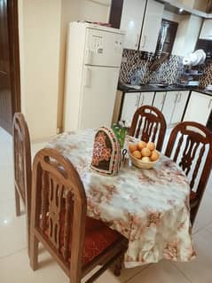 Dining table with 4 wooden chairs for sale.