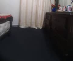 black carpet with foam and beige curtains