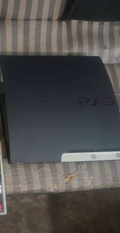 PlayStation 3 slim with one controller and a games 0