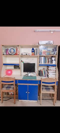 book shelf with 2 chairs