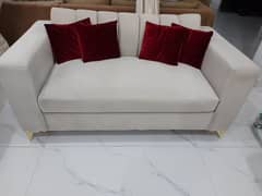 Designer 2 seater sofa with brass finished feet