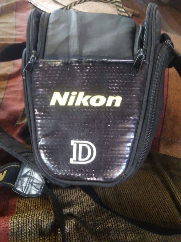 DSLR NIKON D90 WITH 35X70 LENS BATRY CHARGER AND BAG 3