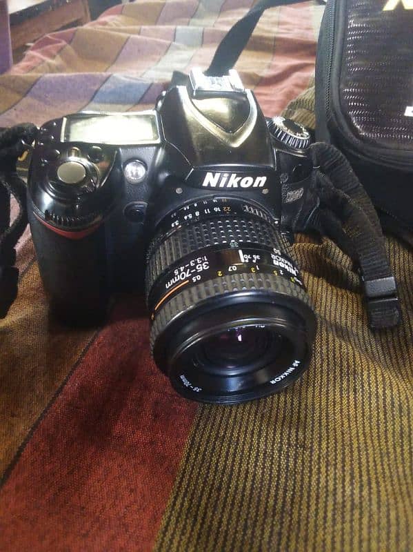 DSLR NIKON D90 WITH 35X70 LENS BATRY CHARGER AND BAG 5