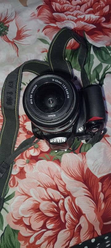 Nikon digital camera and charger  18.55 mm 1:3.5-5.6 camera 1