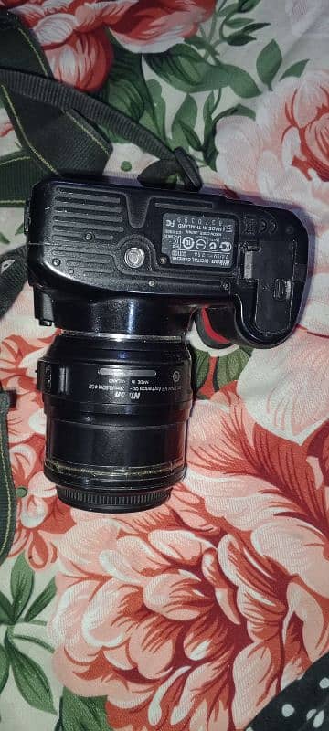 Nikon digital camera and charger  18.55 mm 1:3.5-5.6 camera 2