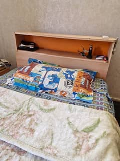 single wooden bed with side table