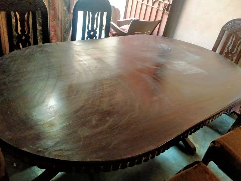 full wooden oval shaped dining table with 6 wooden char 2