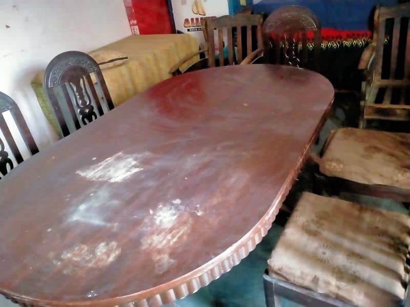 full wooden oval shaped dining table with 6 wooden char 5