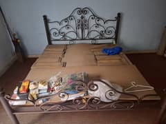 iron double bed and wooden almari