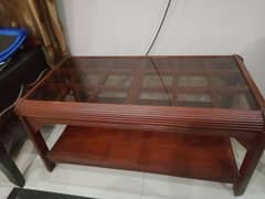 wooden central table made of sheesham wood having brown glass top