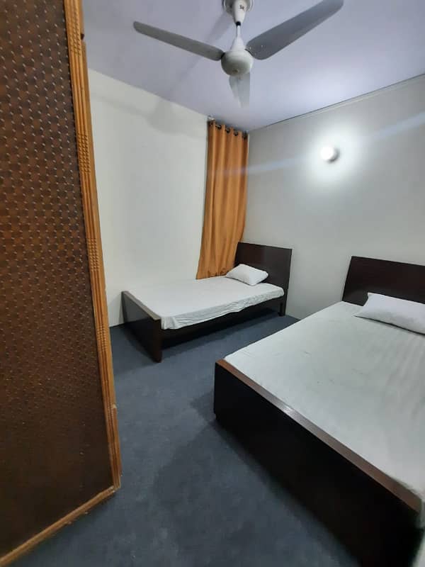 Furnished Independent LDA Flat/ Apartment with Carpeted 2 Rooms for Rent in Q Block Model Town Lahore with AC, Fridge, LED TV, Curtain, Stove, Beds, wood work, UPS, Tiled TV Lounge, Kitchen & bath room Rent = 32000 10