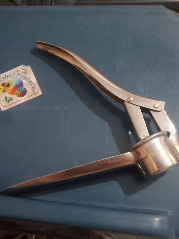 it is a garlic press, kitchen tool to crush garlic لیمو رس نکالنے والا 1