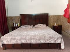 wooden king size bed with side table and mattress