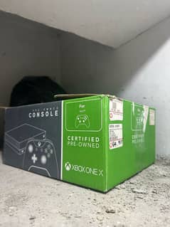 Xbox One X 1 TB with steering wheel setup