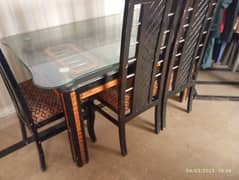 wooden dining table with glass top