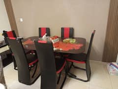 iron rod dining table with six leather chairs. . .