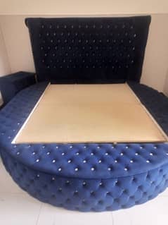 round bed in blue wd side tables