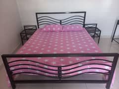 rod iron Queensize bed with sidetables and dressing table