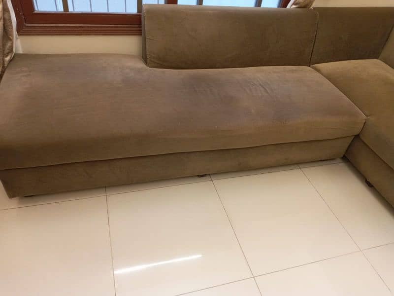 L-shaped sofa with cushions 1