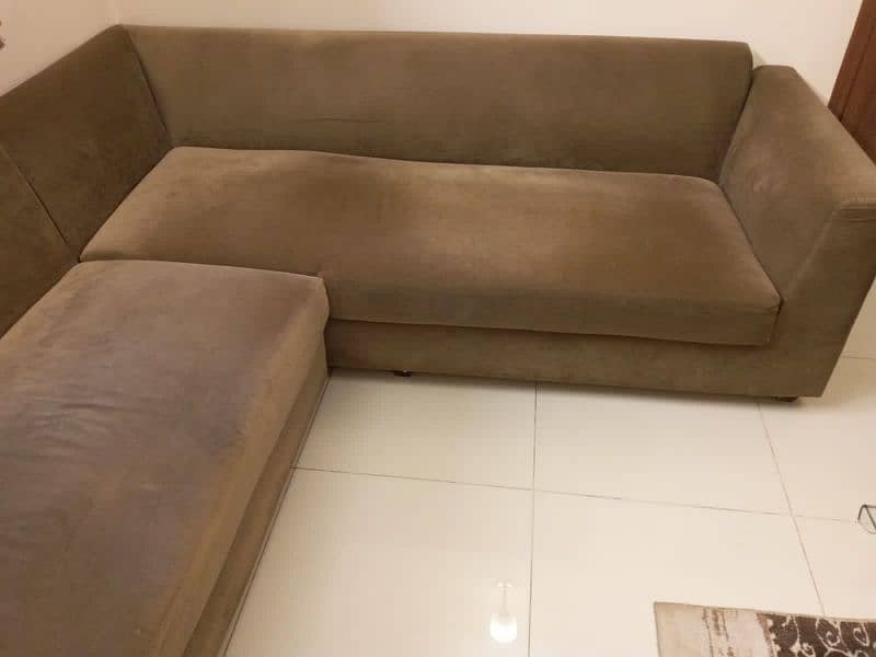 L-shaped sofa with cushions 2