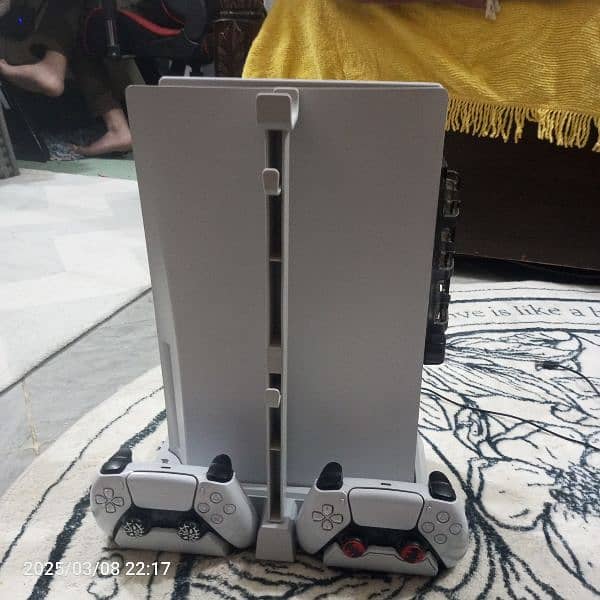 PS5 disk edition two controllers with stand plus charging station. 1