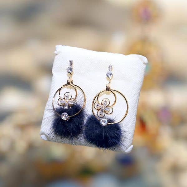 **Product Title:** Elegant Floral Hoop Earrings with Fur Pom-Poms  . 1