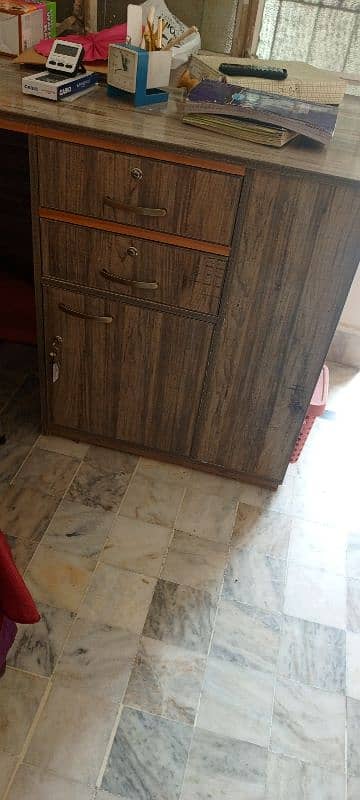 a large study table with drawers and book racks. 2