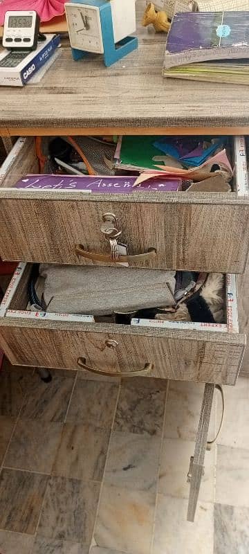 a large study table with drawers and book racks. 5