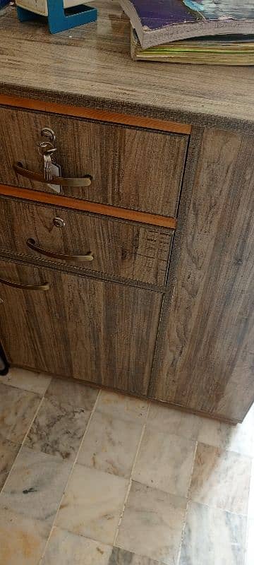 a large study table with drawers and book racks. 8